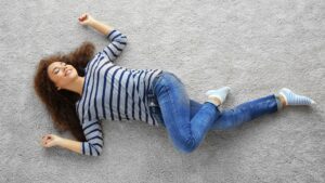 woman laying on clean carpet